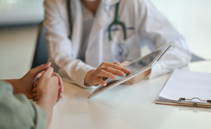Doctor speaking to patient with an i Pad Website image gallery 1