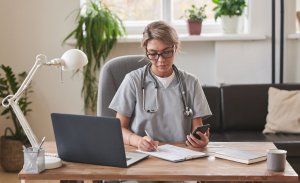 HCP using laptop and phone Design Systems Website image gallery