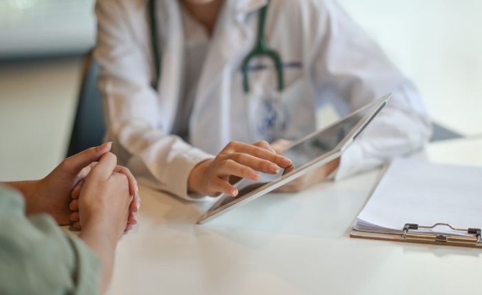 Doctor speaking to patient with an i Pad Website image gallery